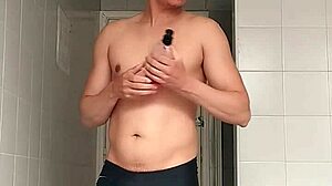 i'm the sexy guy shaving in black beach shorts