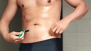 i'm the sexy guy shaving in black beach shorts