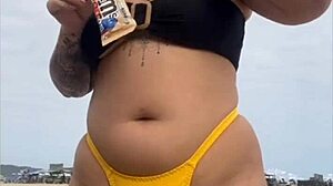 i'm wearing tight bikini to show swollen pussy on beach