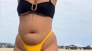 i'm wearing tight bikini to show swollen pussy on beach