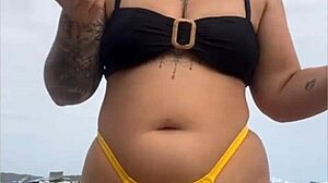 i'm wearing tight bikini to show swollen pussy on beach