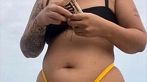 i'm wearing tight bikini to show swollen pussy on beach