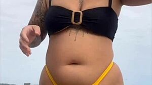 i'm wearing tight bikini to show swollen pussy on beach