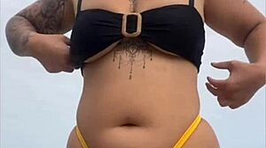 i'm wearing tight bikini to show swollen pussy on beach