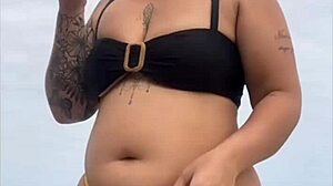 i'm wearing tight bikini to show swollen pussy on beach