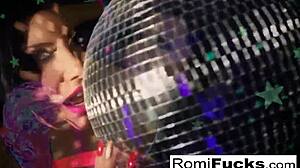 romi plays with a disco ball before stuffing and toying her pussy