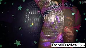 romi plays with a disco ball before stuffing and toying her pussy