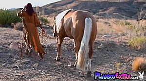 Petite redhead beauty Odette Fox rides horseback outdoors, stripping to reveal big natural tits and pussy.