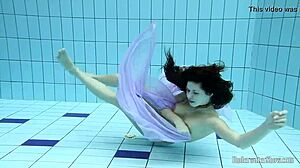 Aneta flaunts big tits in purple dress during pool dip