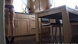 Mrs Scarlet teases in kitchen with stockings and heels during subtle underwear voyeur moment.