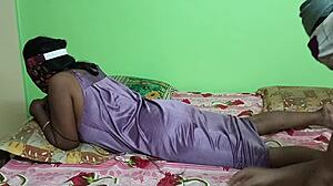 Mature Indian housewife lies on bed in nightdress during boyfriend's back side sex