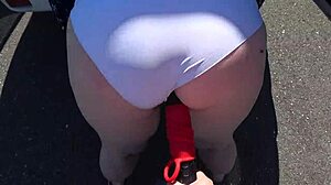 girlfriend straps on dildo to fuck mature milf with fat big ass and saggy tits outdoors near car in pov