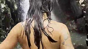 Monika Fox wore a pink top and yellow shorts. She walked naked through the jungle and waterfalls with pierced nipples and fake tits.