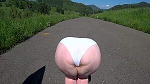 girlfriend straps on dildo to fuck mature milf with fat big ass and saggy tits outdoors near car in pov