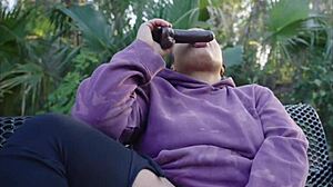 Ebony slut pounds pussy with dildo on public bench