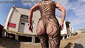 She struts in thong bodysuit along the docks, flashing her big ass outdoors