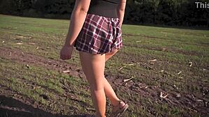 Hot schoolgirl in uniform strolls outdoors while flashing her full back panties upskirt.
