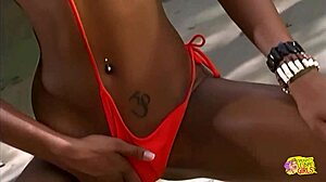 Hey, this ebony lesbian in bikini is fingering and licking her adorable redhead girlfriend outdoors with toys.