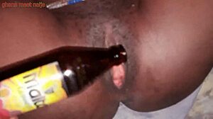 Onion booty ebony Ghana girl fucks malt bottle with big ass shaking. 😏