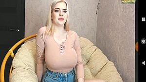 Blonde girl casually shows off her white bigtits during a webcam session.
