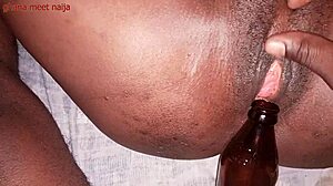 Onion booty ebony Ghana girl fucks malt bottle with big ass shaking. 😏