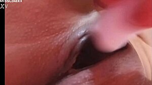 Sensual latina teen masturbates with dildo on bed showing wet pussy lips close-up