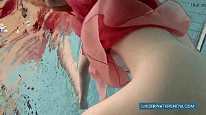 Brunette teen Katya Okuneva poses in red dress by the pool