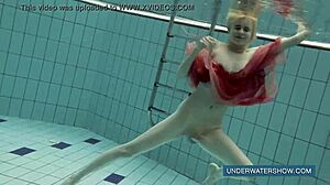 Brunette teen Katya Okuneva poses in red dress by the pool