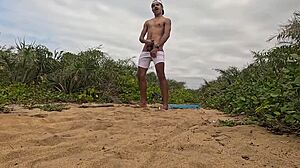 handjob cumshot erupts on beach sands