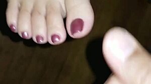 she strokes his throbbing cock between her creamy toes until feet explode