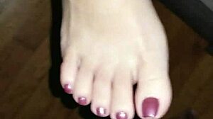 she strokes his throbbing cock between her creamy toes until feet explode