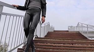 Brunette in tight leather leggings, high heels, and biker jacket dominates outdoors.