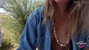 kinky mother flashes pierced nipples and plays outdoors in see-through tease