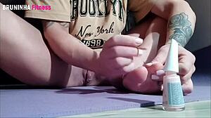 Brazilian beauty paints toenails flashing shaved pussy close-up tease