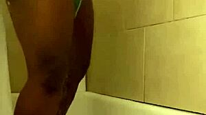 Pretty petite black babe showers prettily