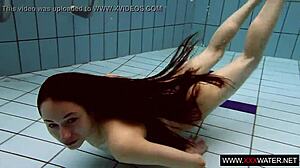 long-haired brunette cutie janka teases underwater in public pool shower