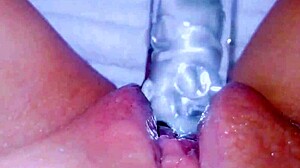 CURIOUS COED SQUIRTS HUGE ON GLASSTOY DILDO