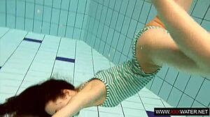 long-haired brunette cutie janka teases underwater in public pool shower
