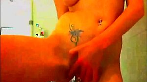 Tattooed model fingers pussy glass dildo bathroom webcam