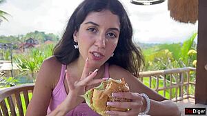 A Cute Brunette Teen Eats Burger Dripping Cum on Face at Public Cafe Cumwalk