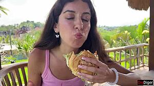 A Cute Brunette Teen Eats Burger Dripping Cum on Face at Public Cafe Cumwalk