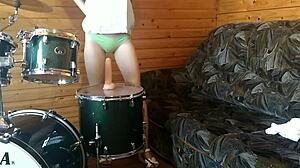 Petite teen rams huge dildo deep in pussy on drumset solo.