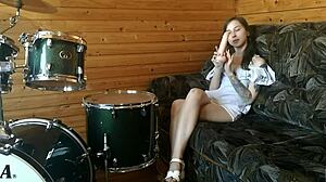 Petite teen rams huge dildo deep in pussy on drumset solo.