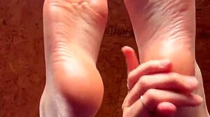 girl slowly lotions her soft feet