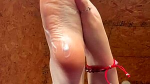 girl slowly lotions her soft feet
