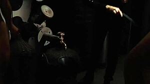 two silk-clad slaves kiss passionately under mistress's sensual watch