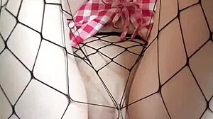 innocent tattooed girl rubs big dildo on pantyhose to cum