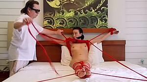 Sofi lies bound on bed with tight red ropes hugging her curves part 2