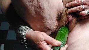 german granny stuffs cucumber deep in her hairy pussy