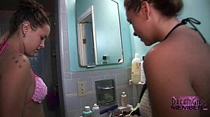 two wild party brunettes tease shaved pussies at beach shower